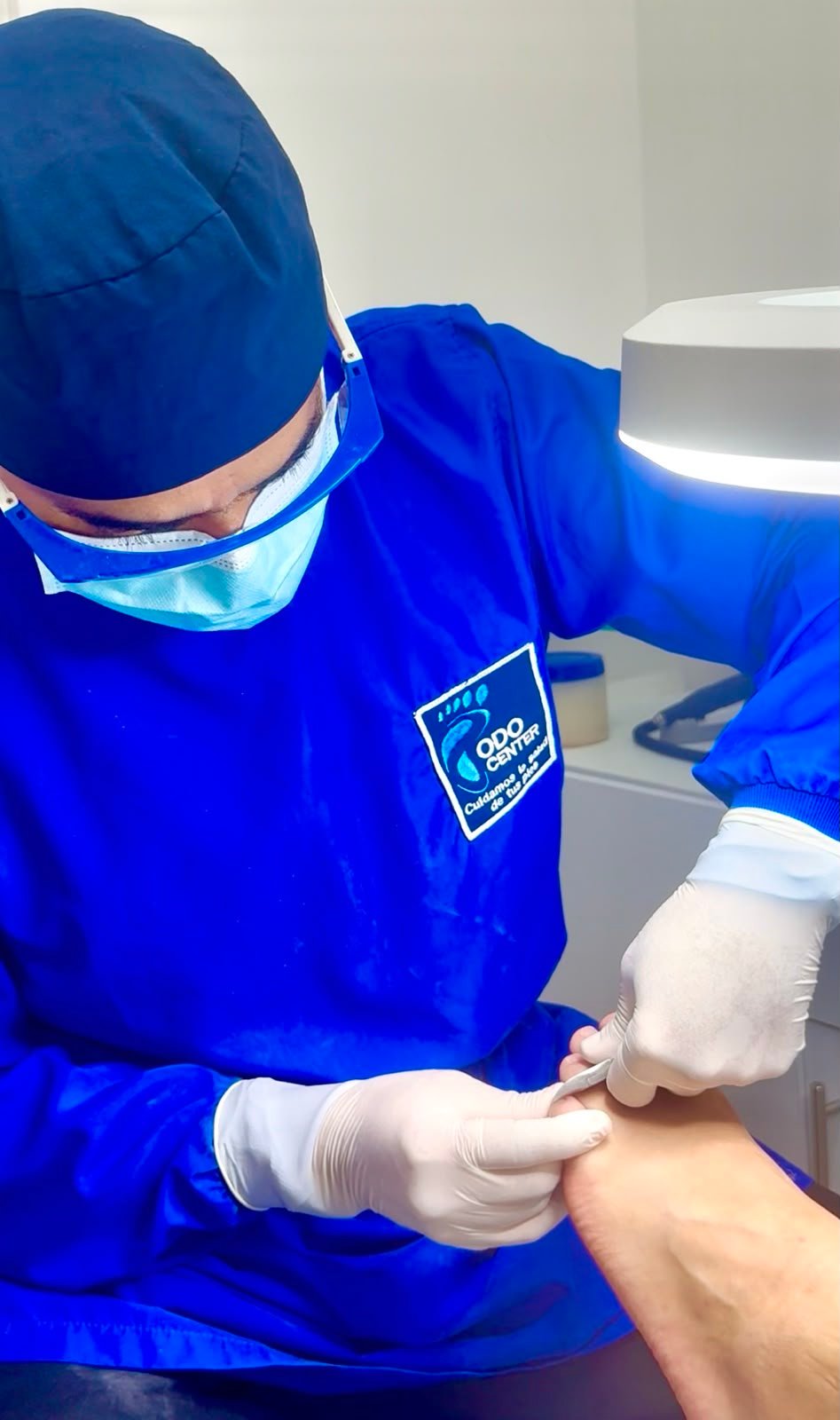 Podólogo realizando procedimiento en sala equipada de Podo Center